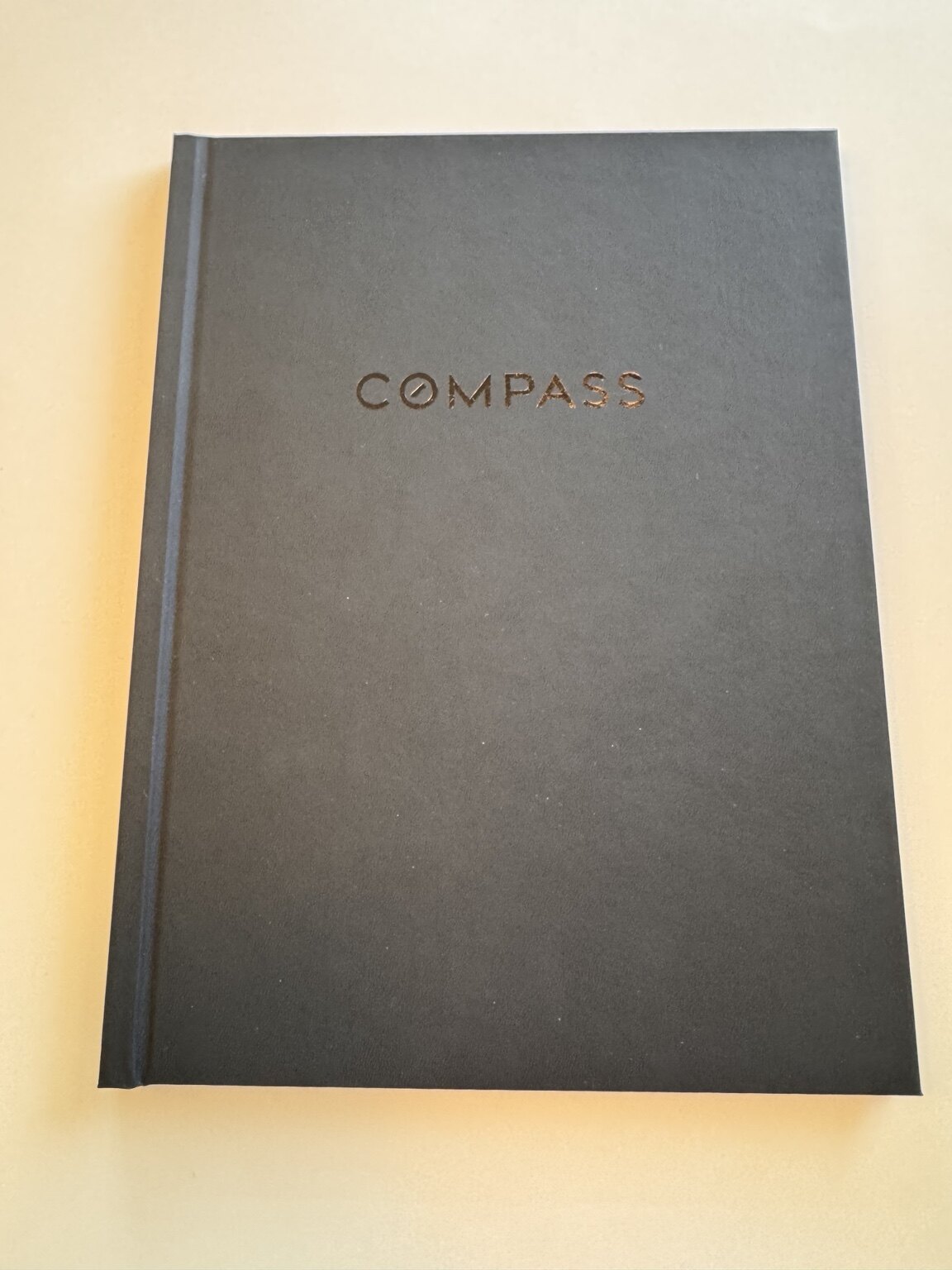 Black hardcover Compass property information book prepared by LeMaire Property Advisory